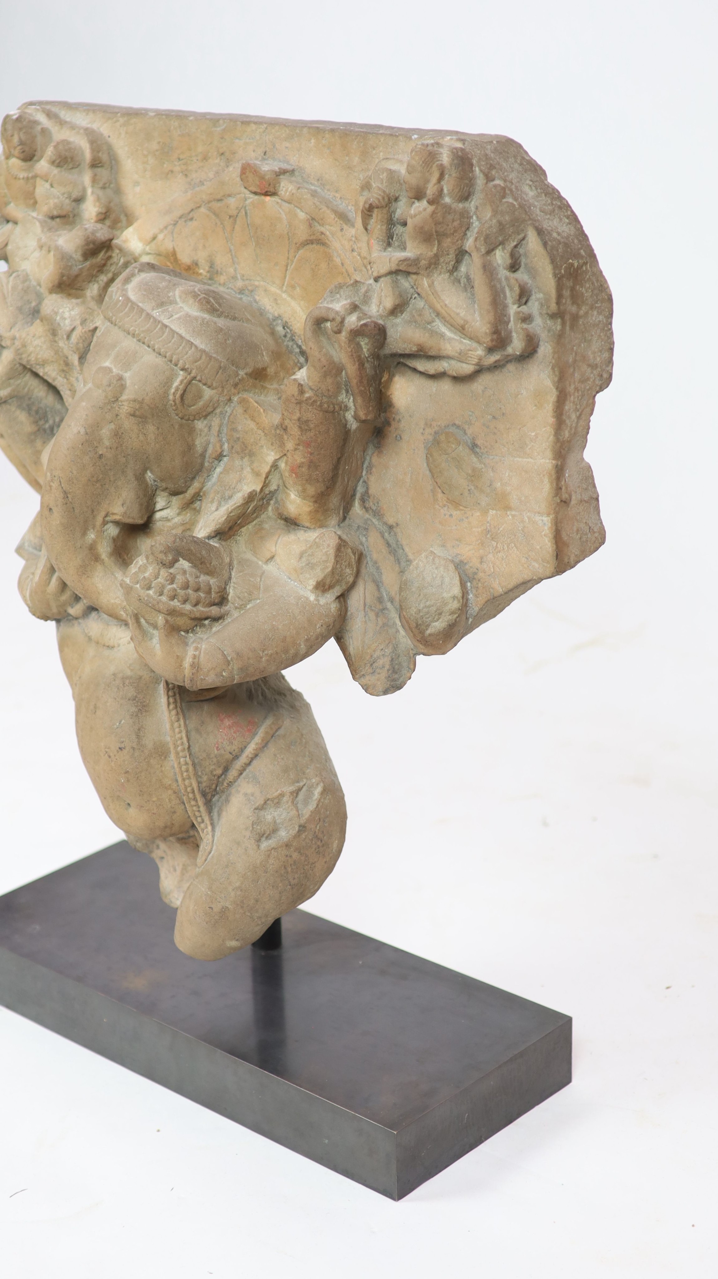 An Indian sandstone Ganesha stele fragment, Rajasthan 11th/12th century, 66cm high, 60 cm wide, excluding metal stand